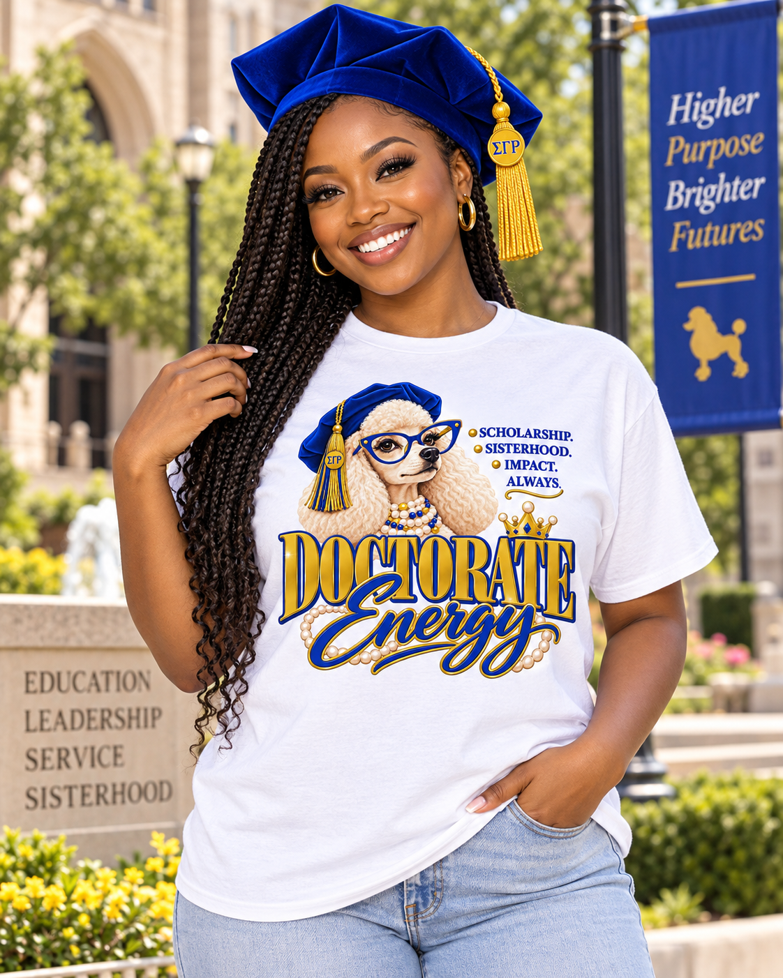 Black woman wearing Doctorate Energy white shirt and royal blue doctoral tam on a university campus